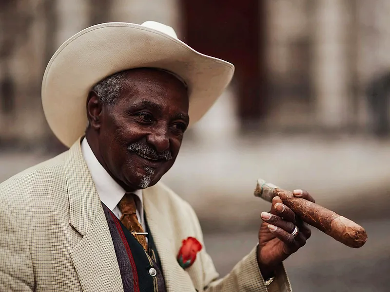 A distinguished gentleman savoring a premium cigar