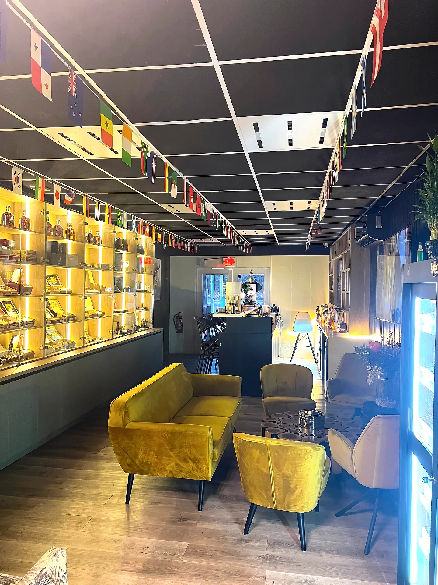 Velvet lounge seating beside the lit cigar display at VIP Cigar Lounge