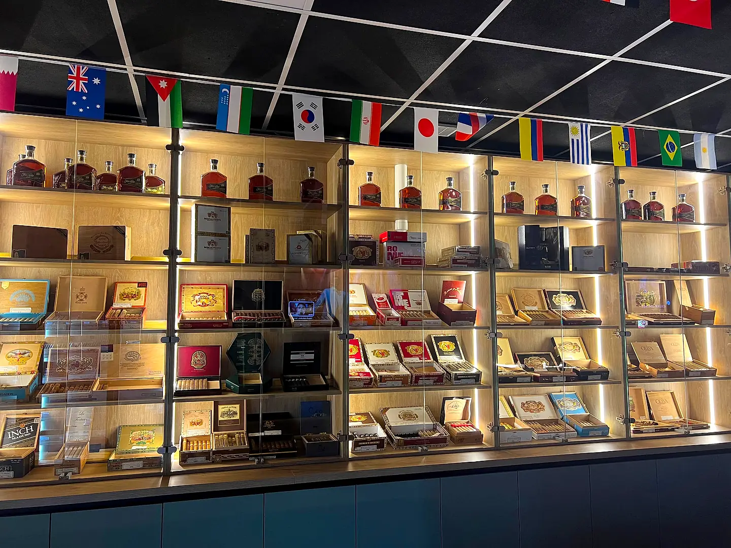 The lit cigar and rum display wall inside VIP Cigar Lounge in Willemstad, Curaçao